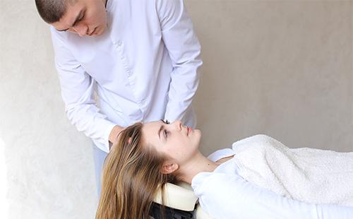 Мужчина делает массаж головы женщине